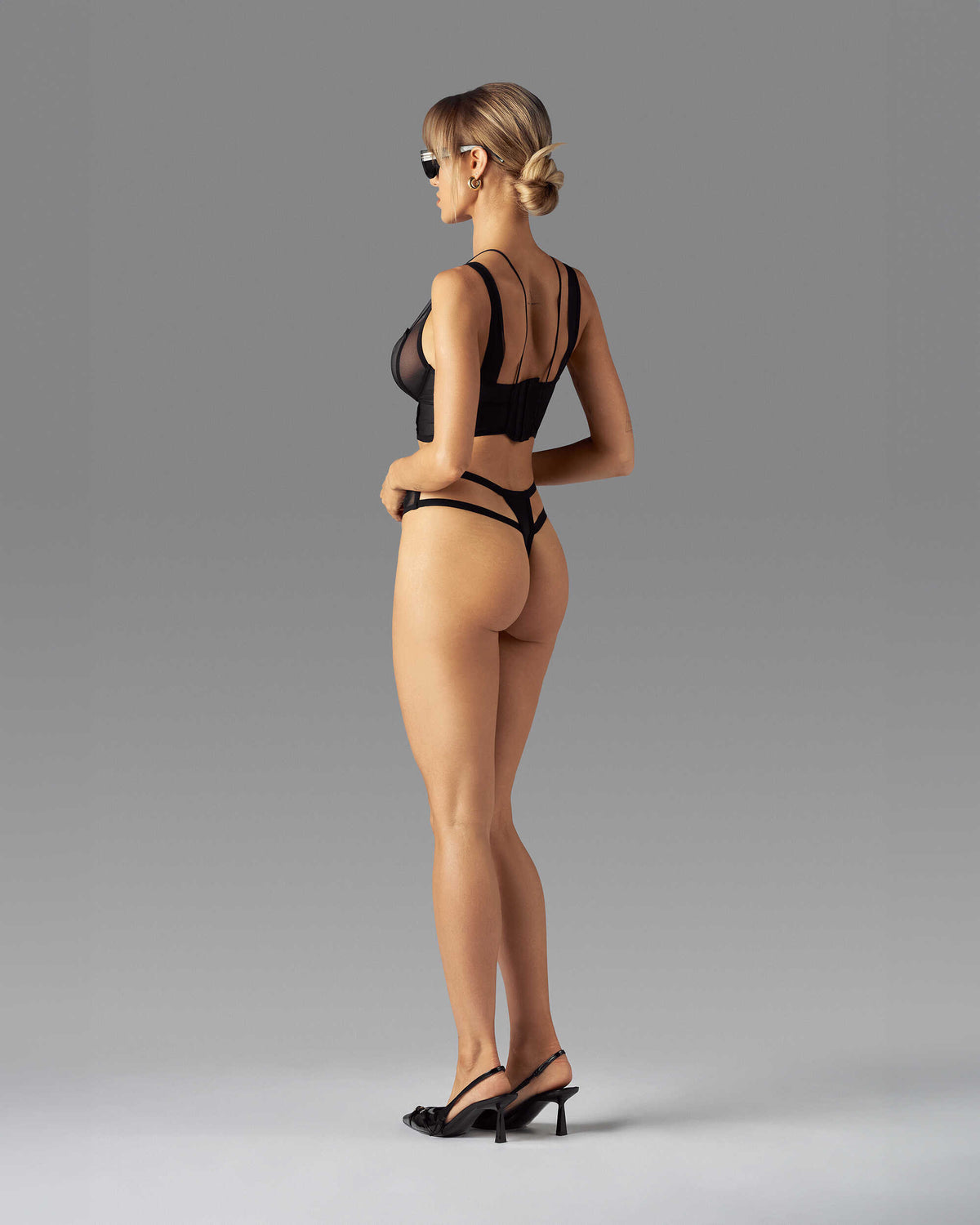 Nuites black mesh double thong featuring vertical front seams and side boning