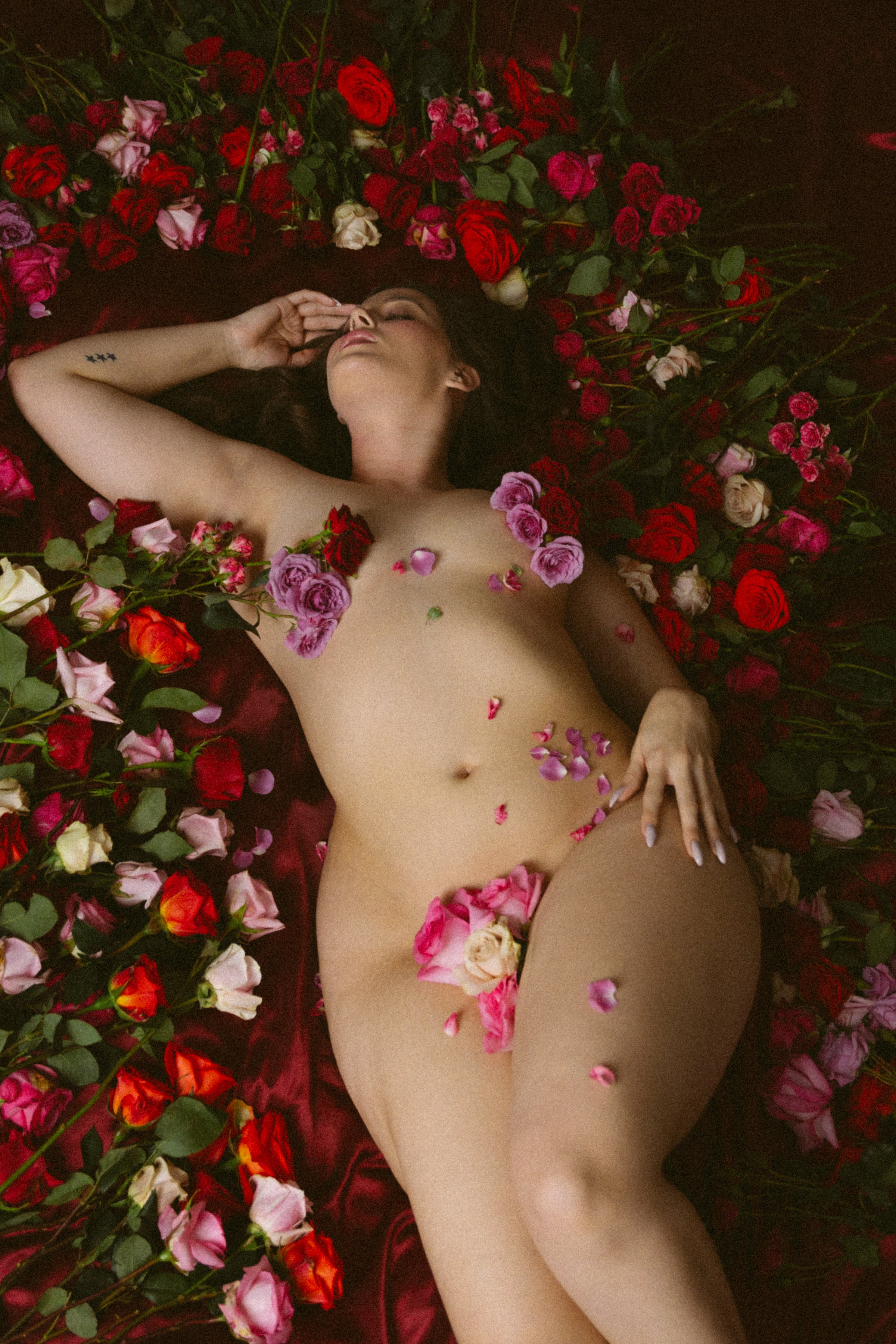 Editorial erotic photography — model surrounded by roses celebrating sensuality and desire at nympho life, photo by Bralettes and Brunch