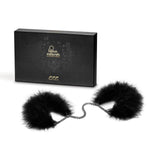 Black feather-trimmed handcuffs with lush black feathers and an adjustable fit